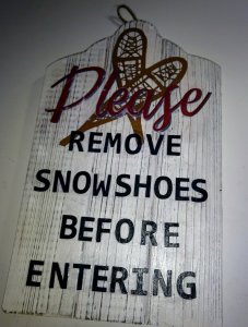 Front door sign - please remove snowshoes before entering.